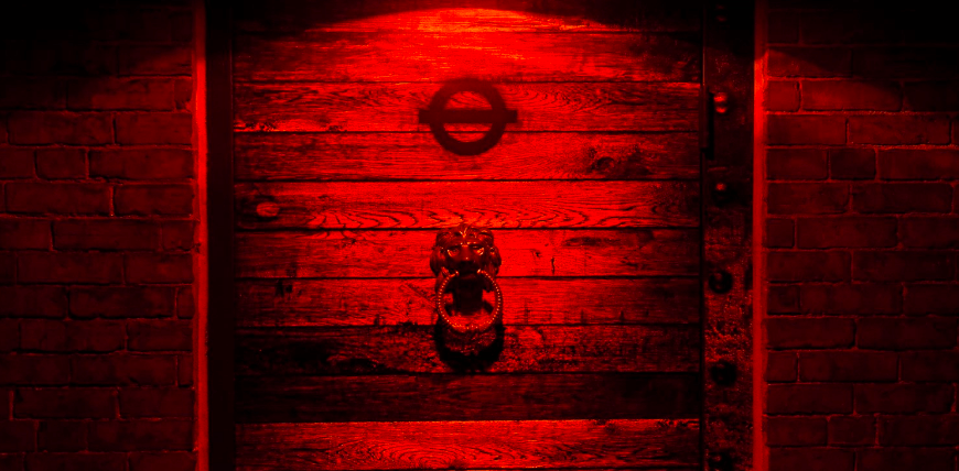 a red light is shining on a brick wall.