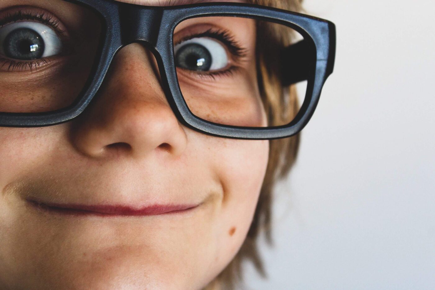 a close up of a person wearing glasses.