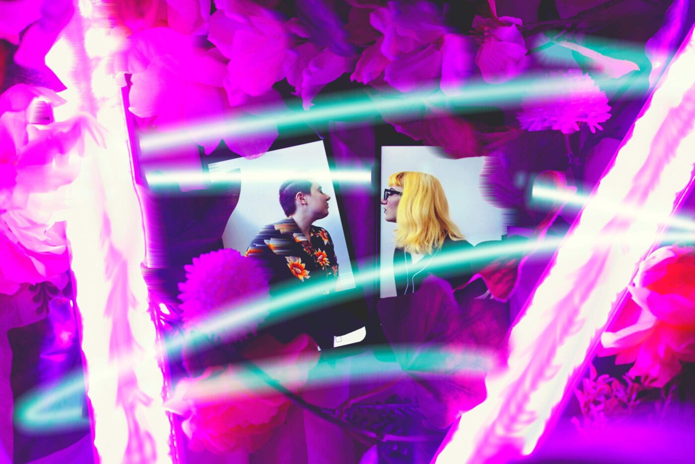 a man and a woman standing in front of a mirror.