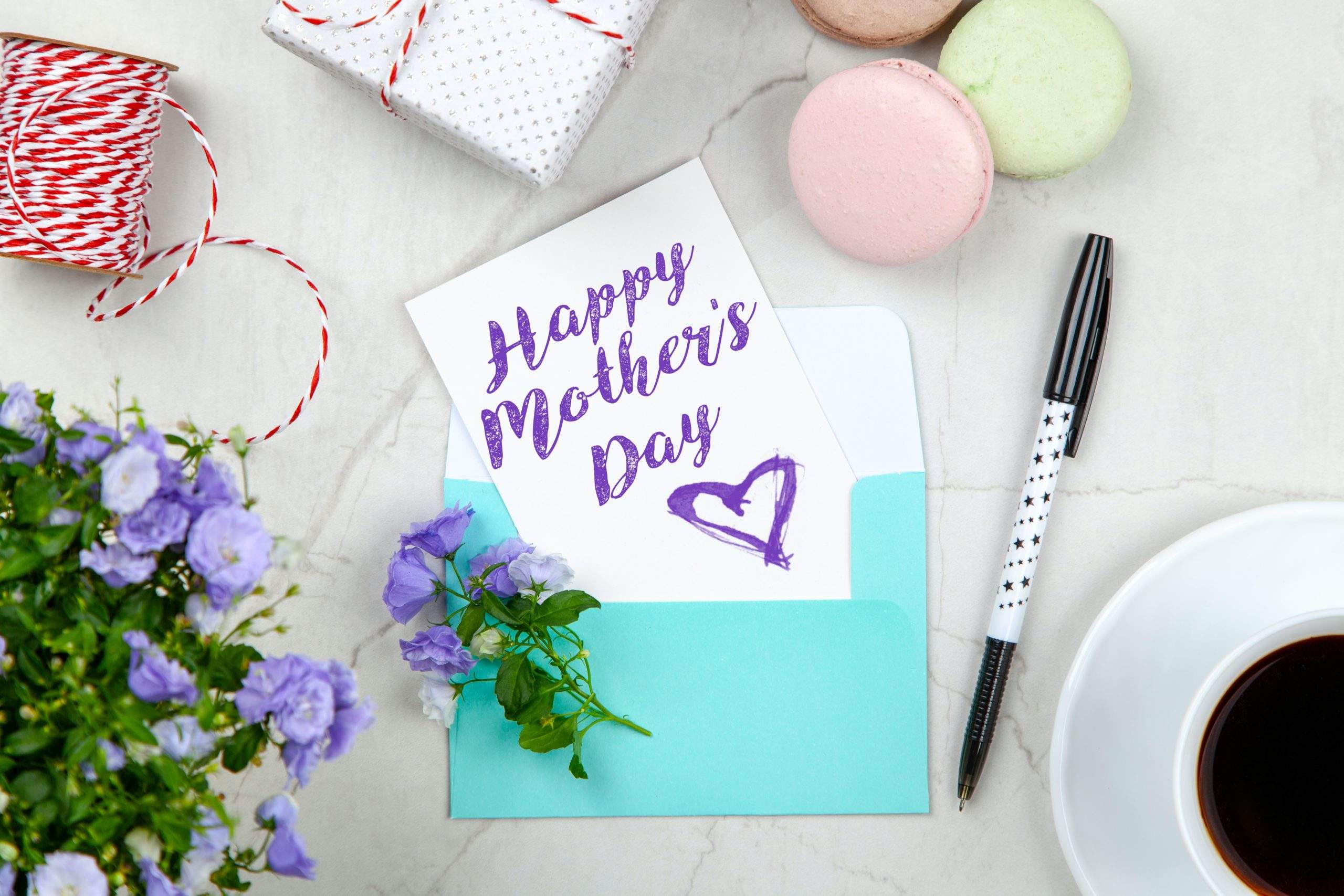a mother's day card next to a cup of coffee.