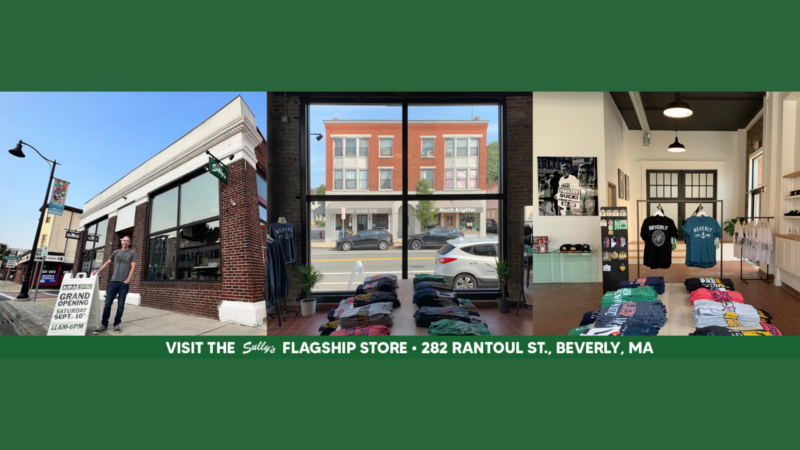Experience the vibrant flair of Sully's Brand clothing store at 282 Rantoul St, Beverly, MA. Step inside to discover a dazzling array of colorful shirts stacked to perfection. Outside, catch the excitement as a man stands proudly next to our Grand Opening sign. Join us and redefine your wardrobe with style and color!