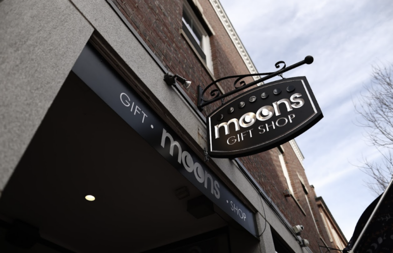A visible sign for Moon's Coffee Shop positioned on a building facade.