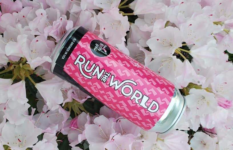a can of run world on a bed of flowers.
