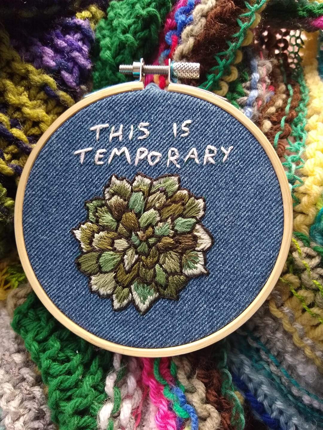 a close up of a embroidery on a piece of cloth.