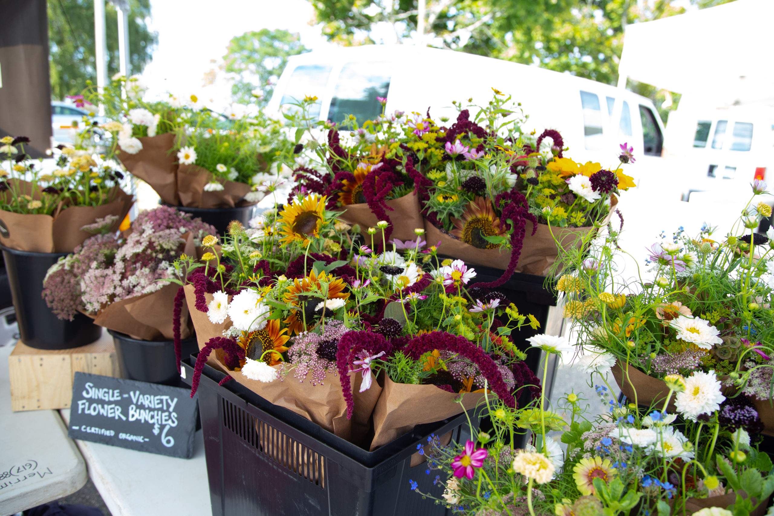 Bouquets of flowers fill baskets at the Salem Farmer's Market