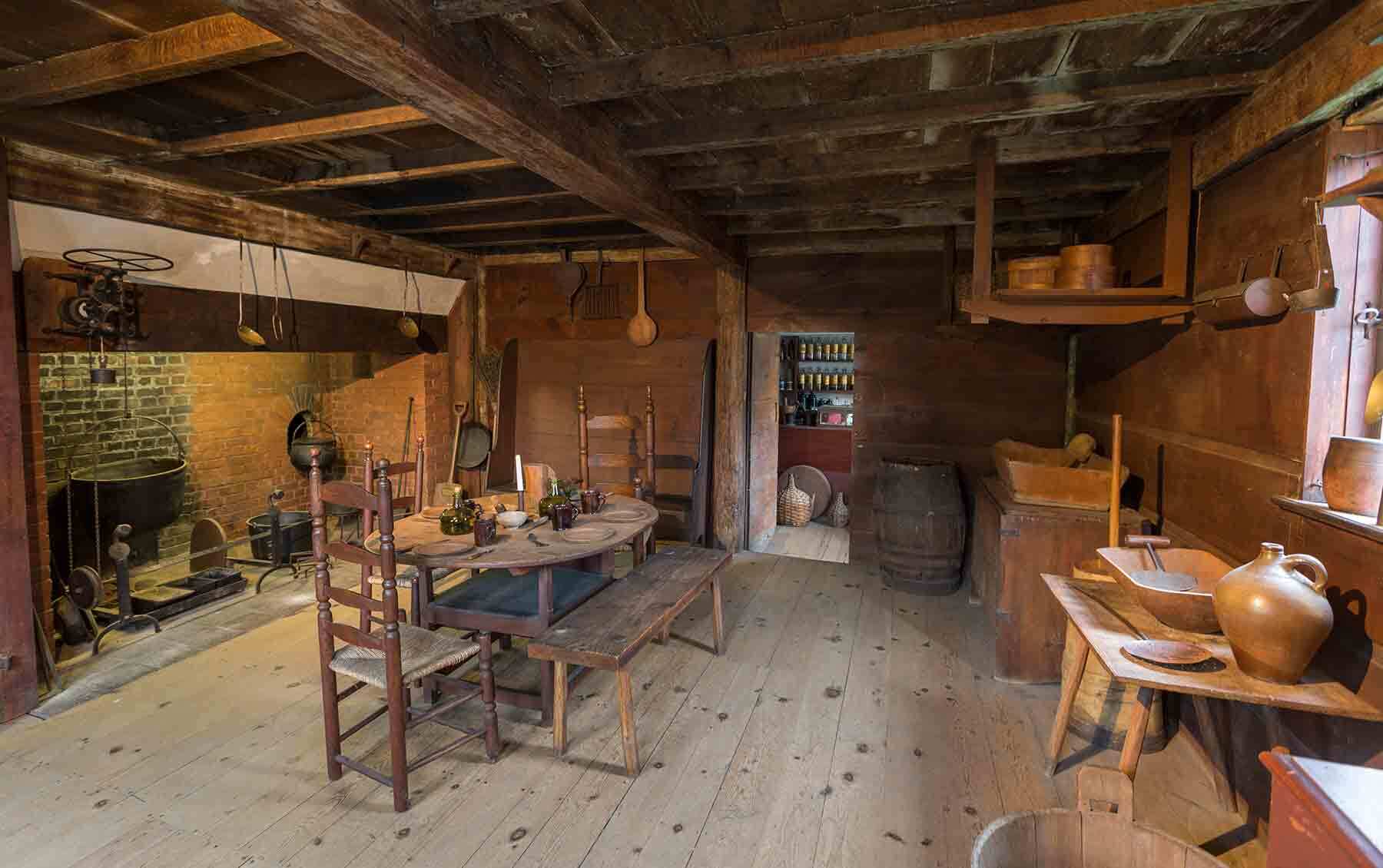 a room with a table, chairs, and a fire place.