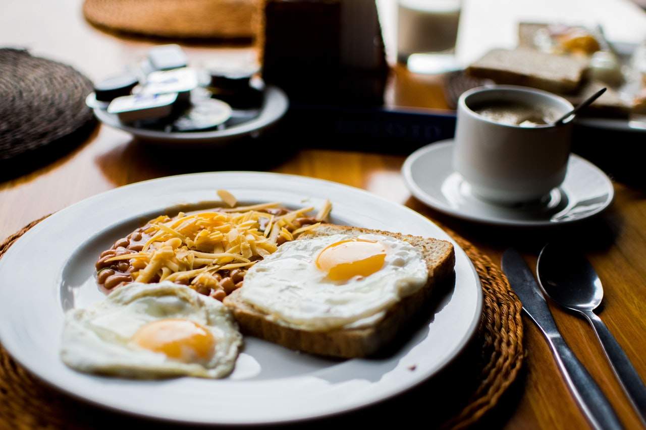 a white plate topped with eggs and toast.
