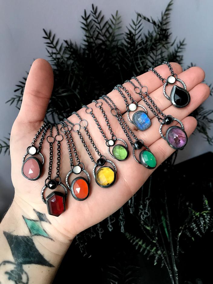 a person's hand with a bunch of charms on it.