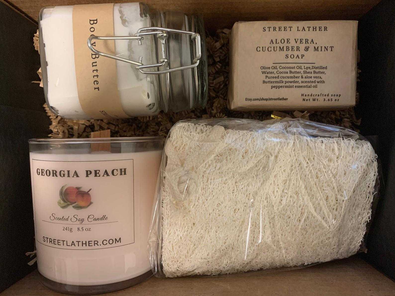 a box with a candle, soap, and other items.