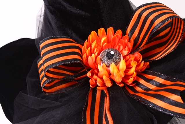 a black and orange bow with a flower.