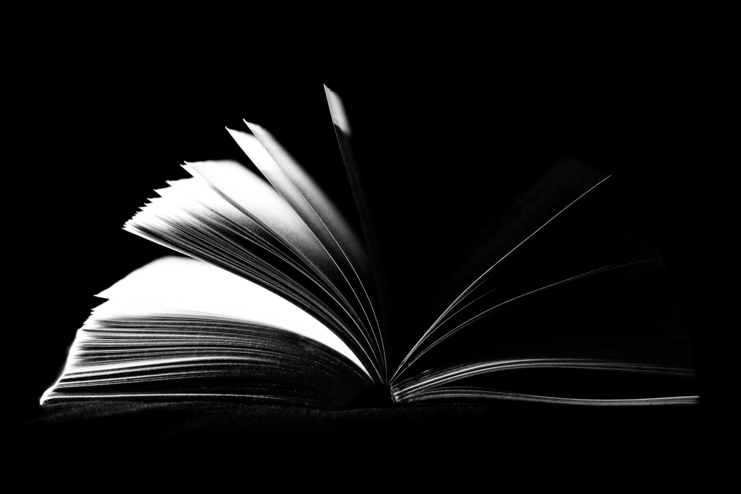 a black and white photo of an open book.