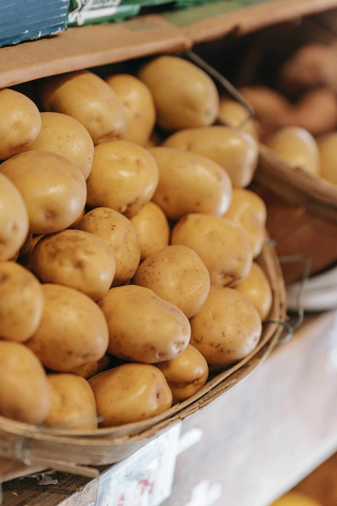 a basket of potatoes on a shelf in a store.