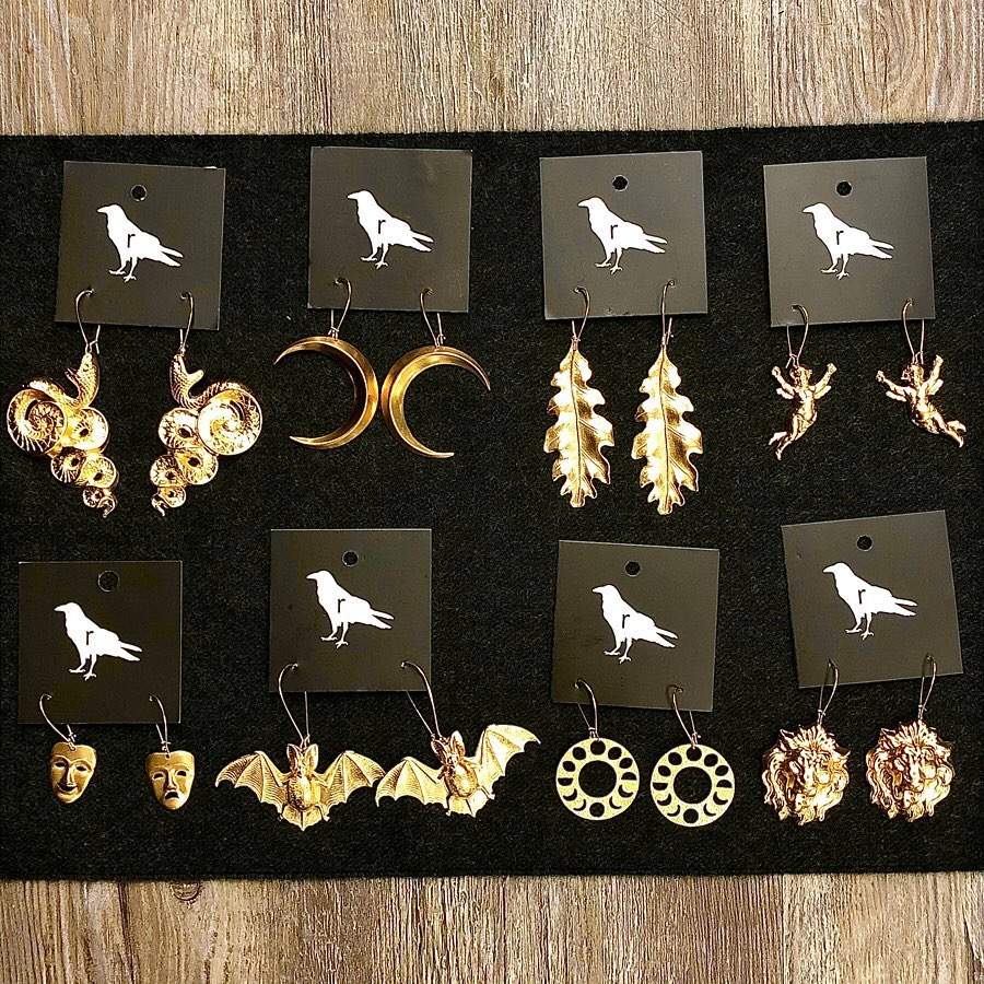 a collection of earrings on display on a table.