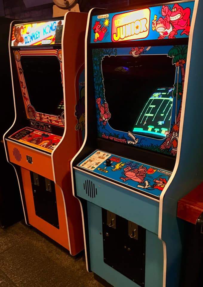 a couple of arcade machines sitting next to each other.