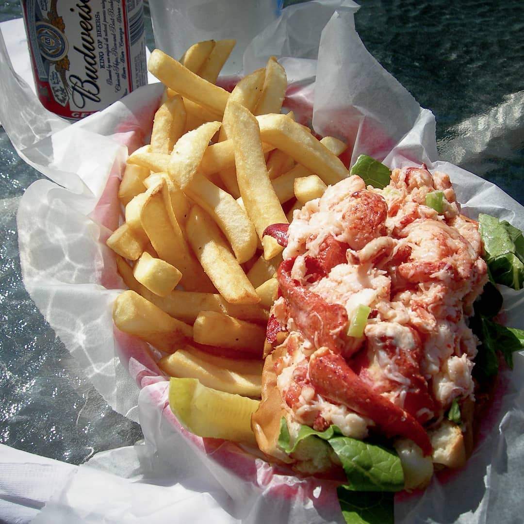 a lobster sandwich with fries and a beer.
