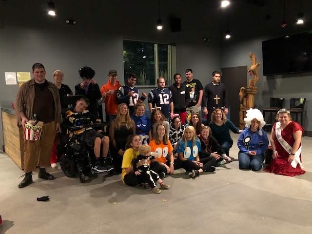 a group of people in costumes posing for a picture.