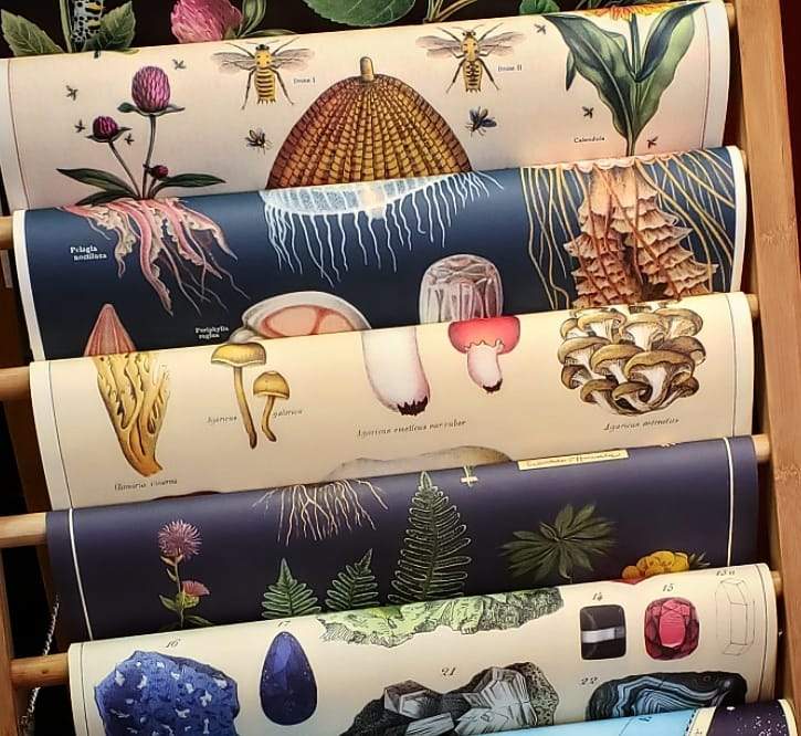 a stack of different types of fabric on a rack.