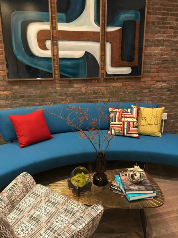 a living room with a blue couch and a round coffee table.
