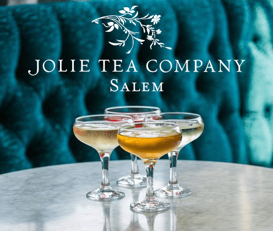 three glasses of wine sitting on a table with the name jolie tea company salem.