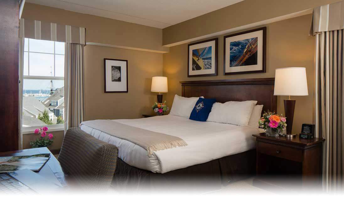 a hotel room with a large bed and pictures on the wall.