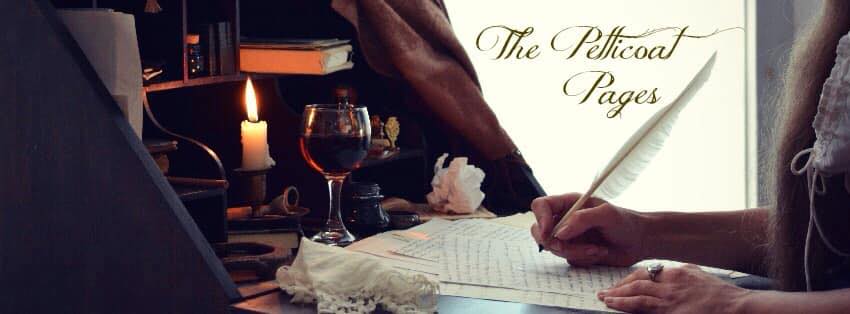 a person writing on a notebook with a glass of wine in the background.