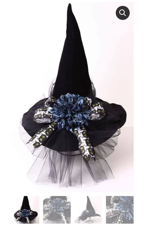 a black hat with a blue flower on top of it.