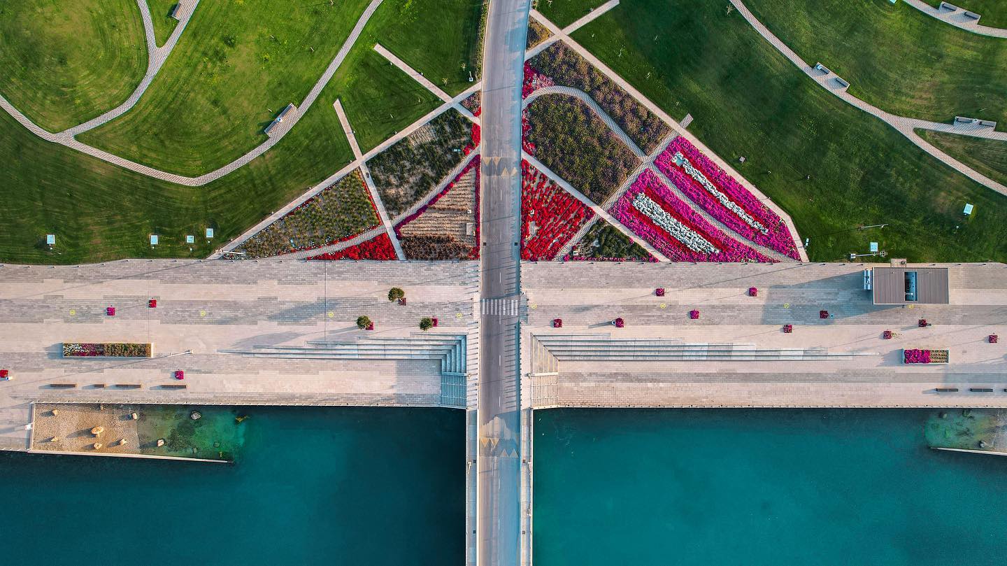 an aerial view of a bridge over a body of water.