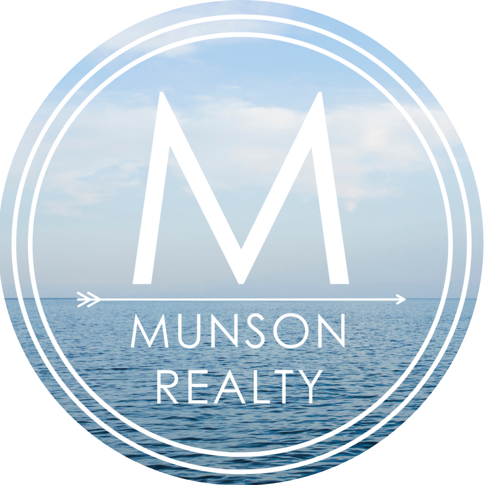 the logo for munson realty.