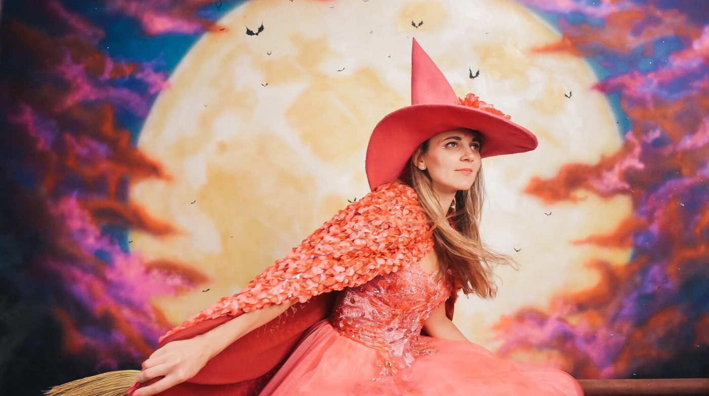 a woman in a red dress and a red hat.