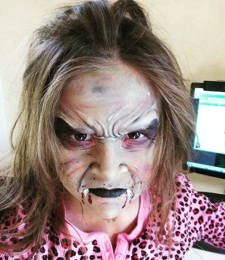 a woman with makeup and makeup art on her face.
