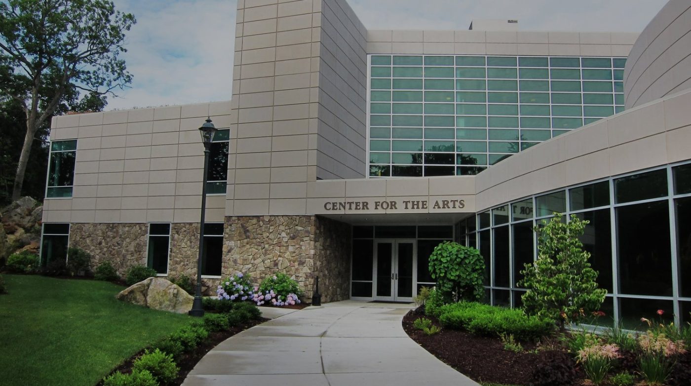 a large building with a walkway leading to it.