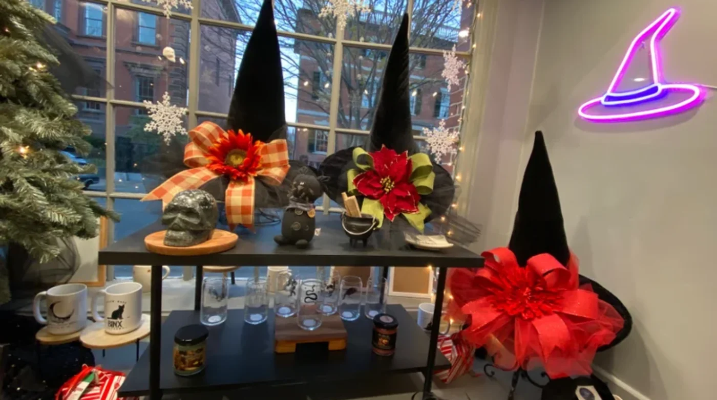 A display of witch hats and decorations in a store window.