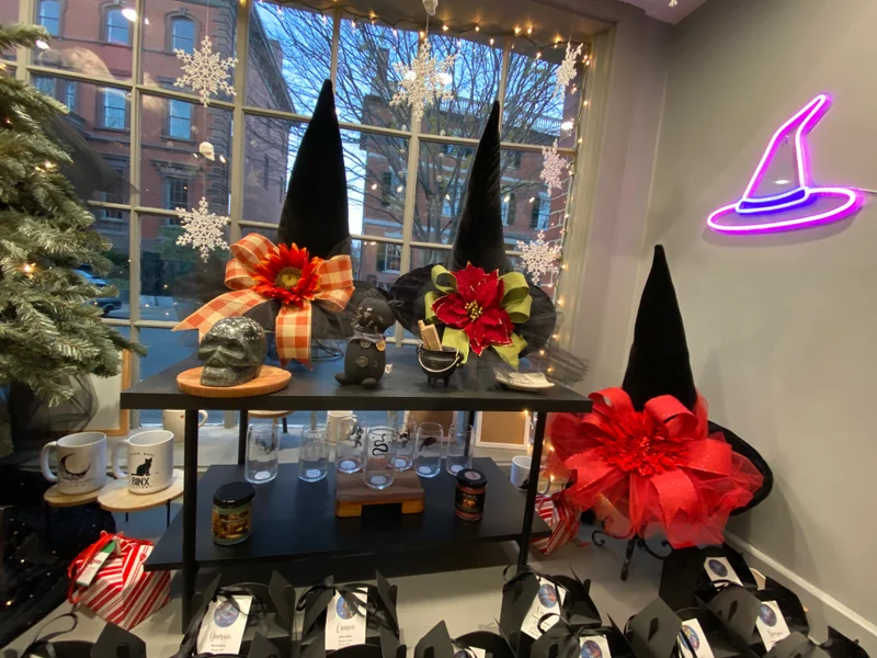 A display of witch hats and decorations in a store window.