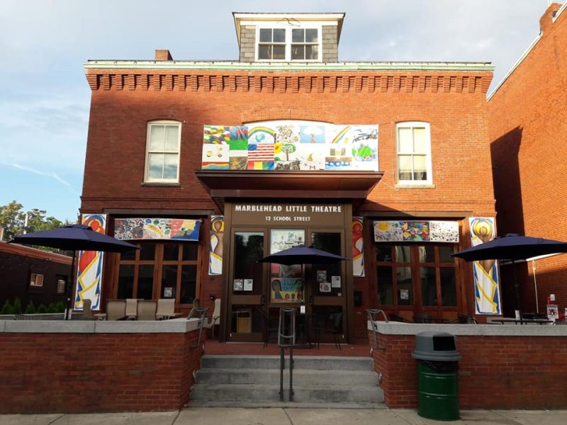 a brick building with two umbrellas in front of it.