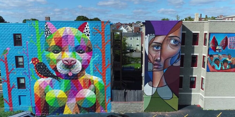 a mural of a woman and a dog painted on a building.