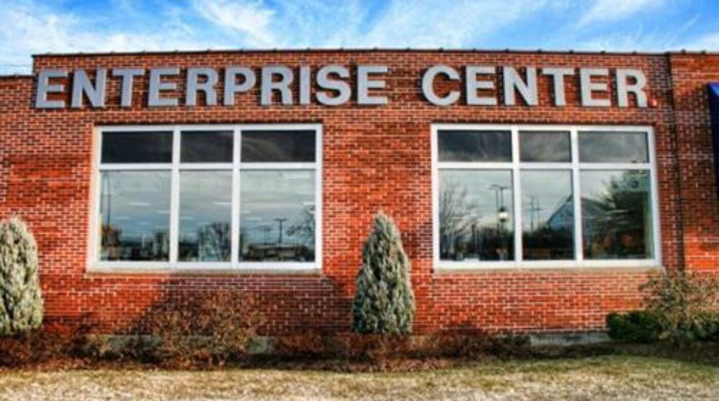 a brick building with a sign that says enterprise center.