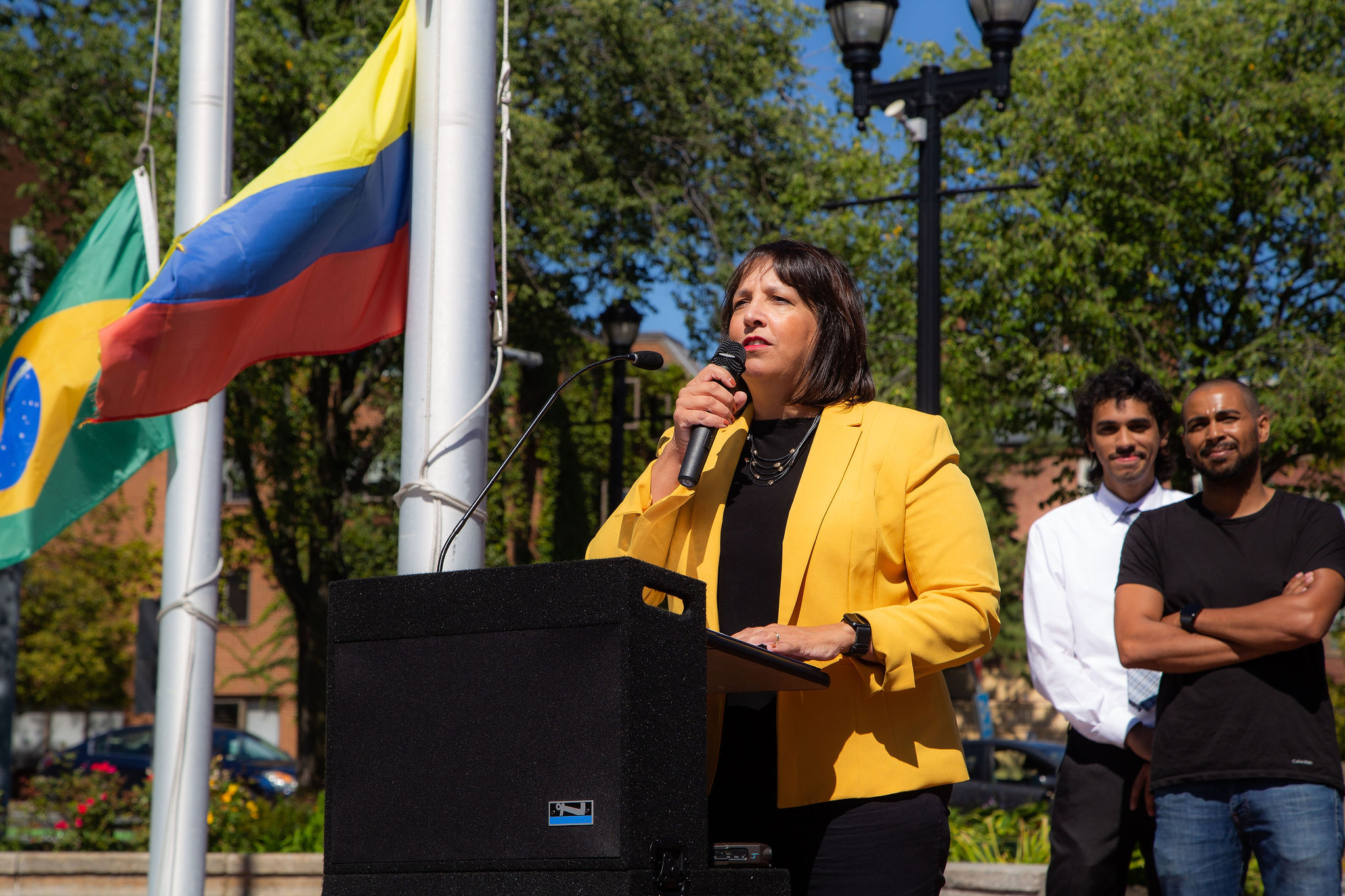 Mayor Kim Driscoll speaks behind the podium during the Latinx heritage month flag raising