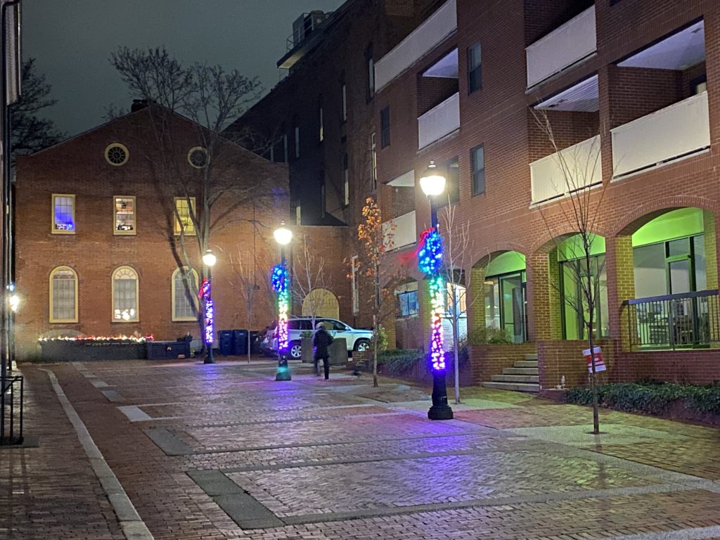 Colorful illuminated tree installations along a downtown Salem street during Salem Winterlude.
