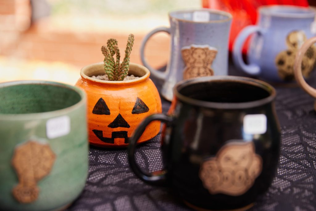 Handmade jack-o'-lantern pottery displayed at the Haunted Happenings Marketplace in Salem.