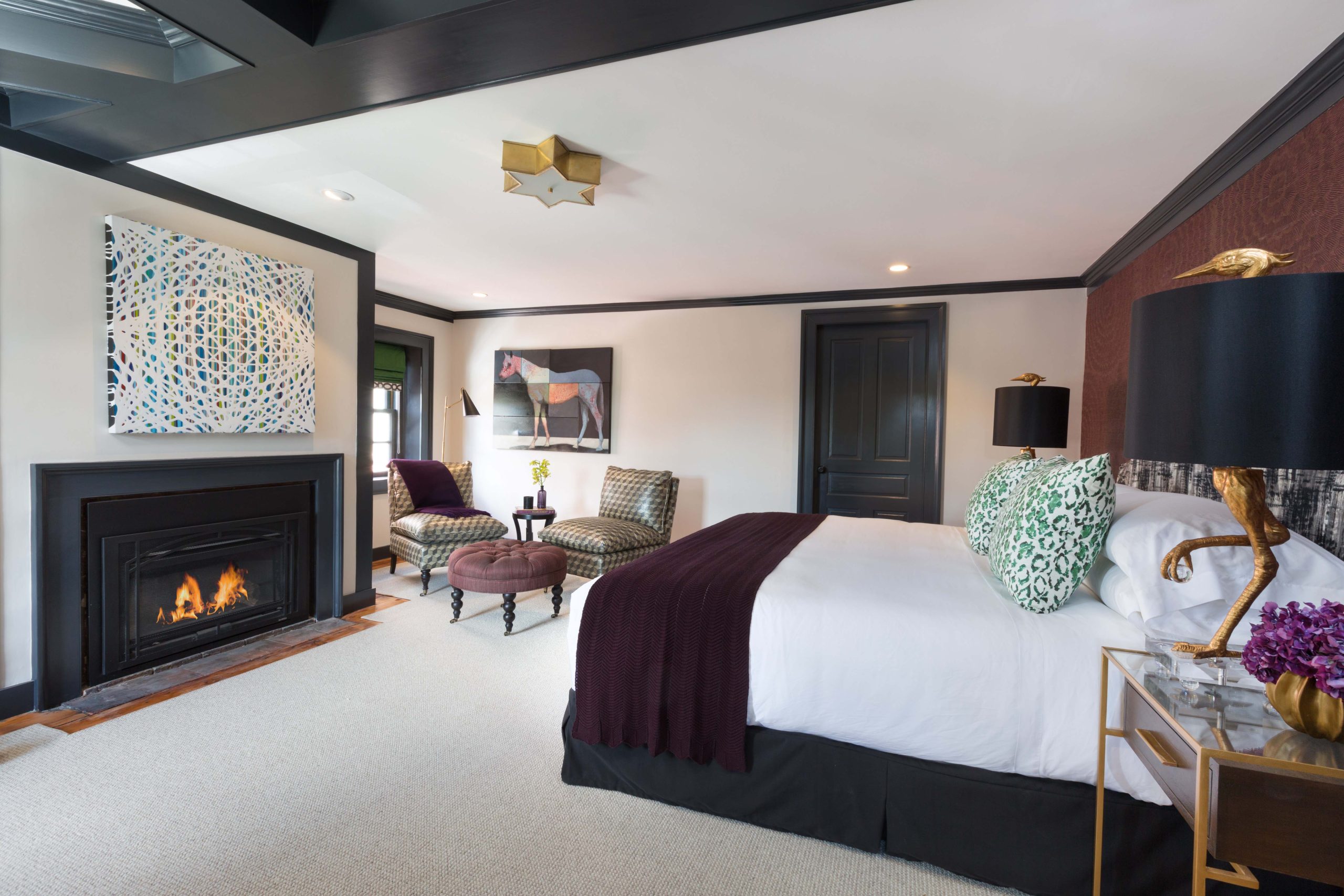 a bedroom with a fireplace and a bed.