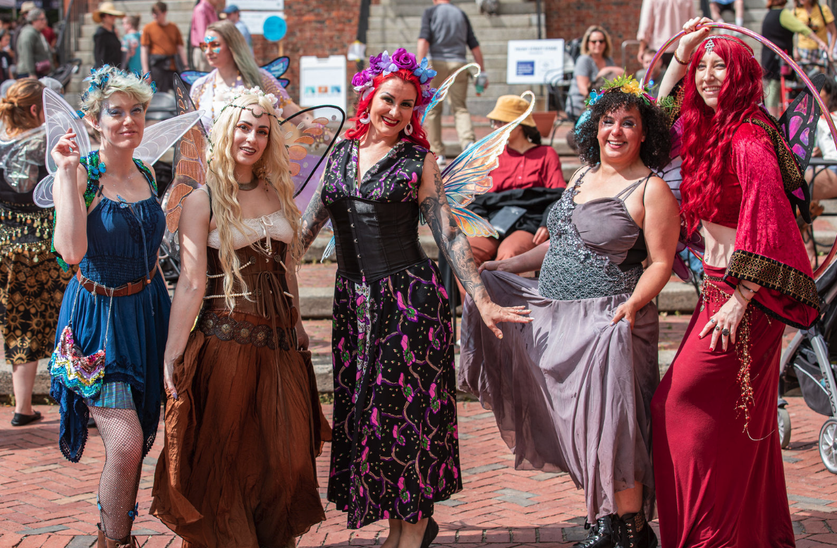 a group of women dressed in costume posing for a picture.