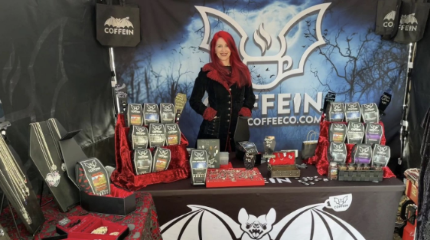 A woman standing in front of a table with bats on it.