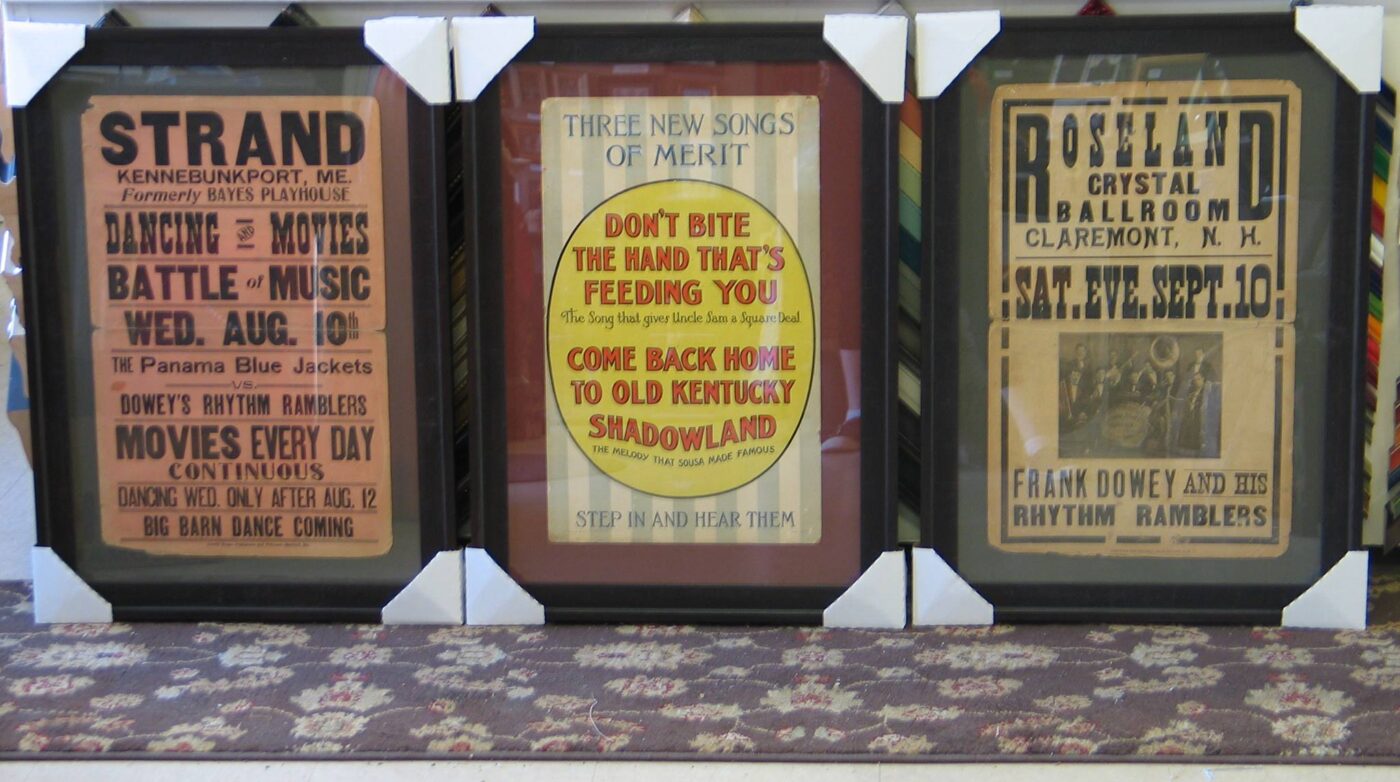a group of three framed posters on a wall.
