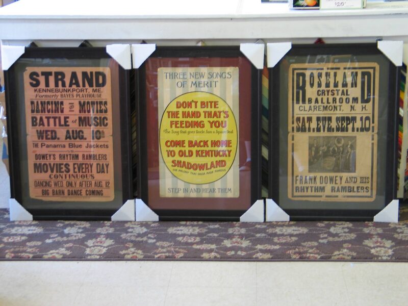 a group of three framed posters on a wall.