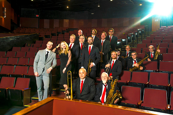 a group of people in suits and ties posing for a picture.