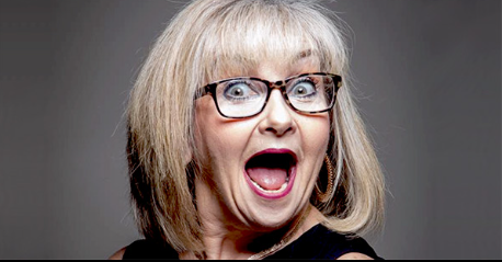 a woman with glasses making a funny face.