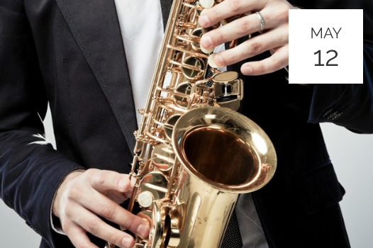 a man in a suit playing a saxophone.