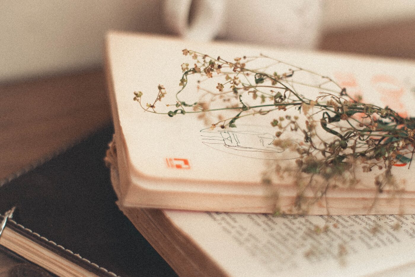 a stack of books sitting on top of a wooden table.