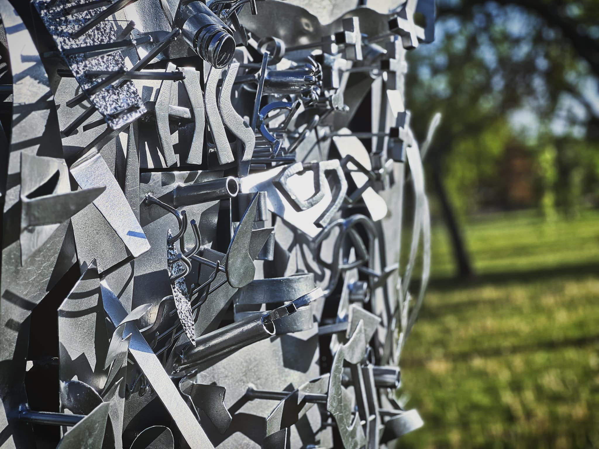 a close up of a metal sculpture in a park.