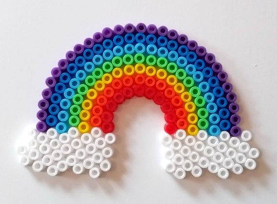 a rainbow made out of legos on a white surface.